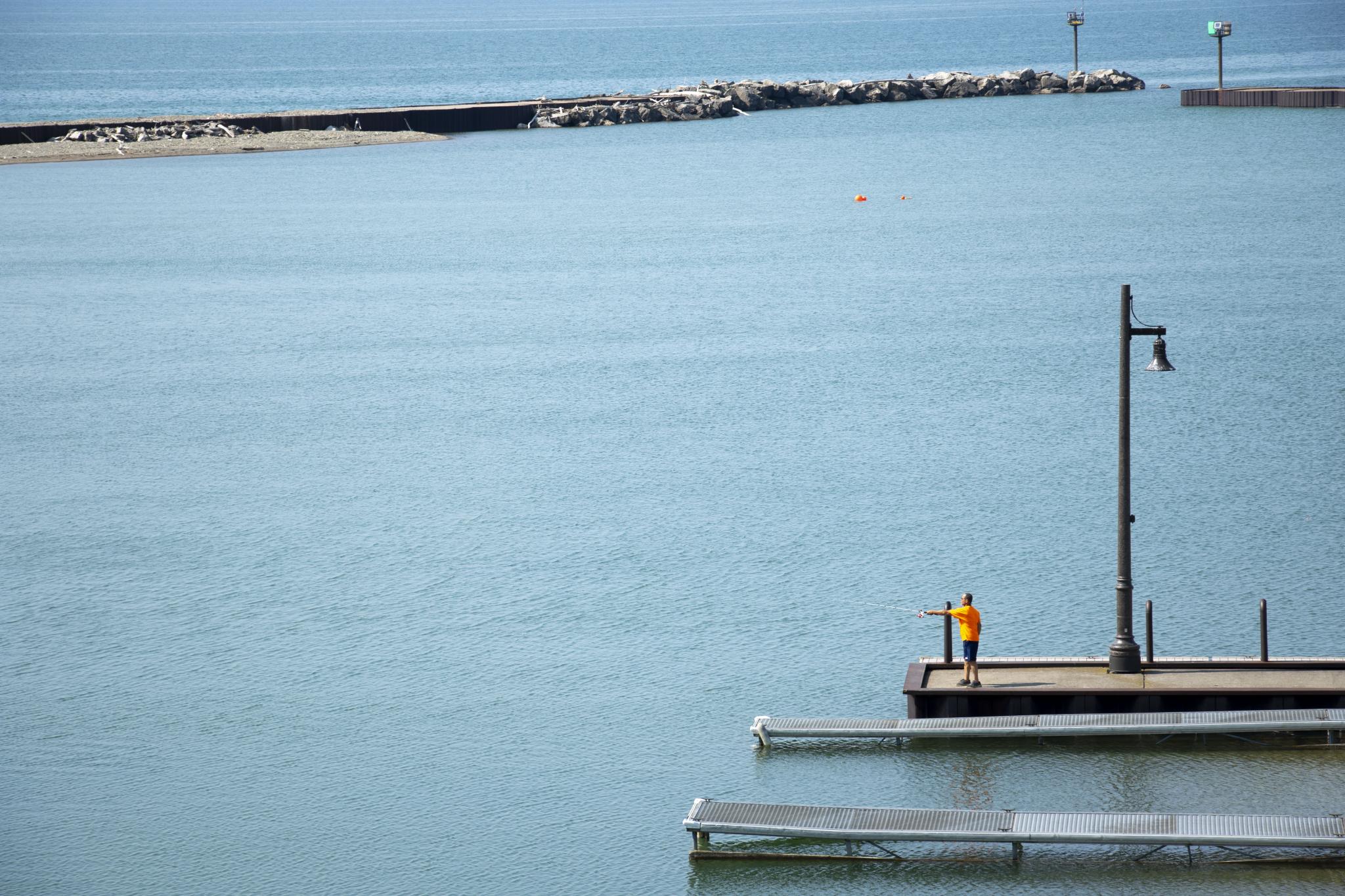 Guy fishing off the pier