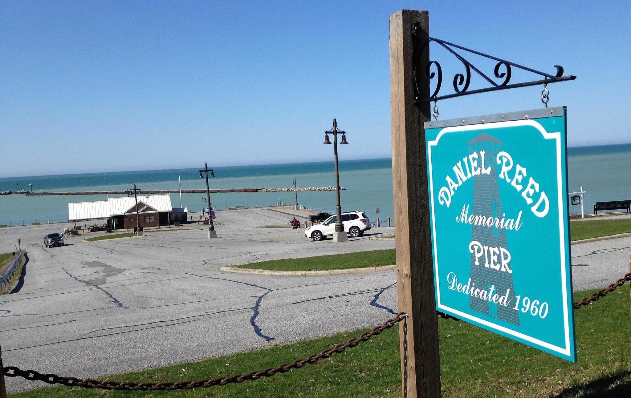 “Pictured is the sign at the top of the Daniel Reed Memorial Pier with some of the pier in the background.”