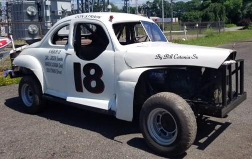 #18, 1941 Mercury race car: replica of a race car driven by Don Strain at Coon Road Speedway, built by Bill Catania. The original #18 was built by Bill's father, Marion Catania, and Carl "Swede" Larson. Photo taken 7-4-18 at Ottaway's Auto Body in Westfield.